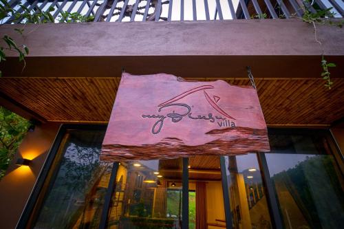 a sign that is hanging in front of a building at MyBinsu Villa - Venue Travel in Ba Vì