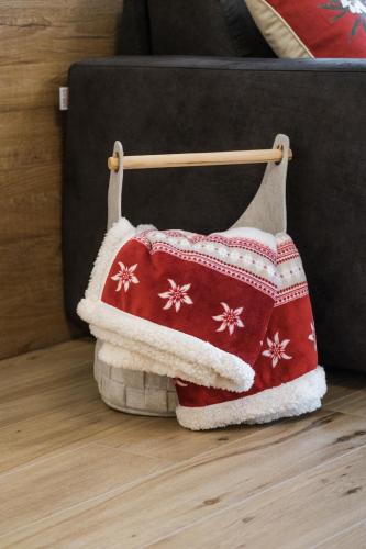 a red and white sweater hanging on a towel rack at La Dila Dolomiti Mountain Lodge in Andalo