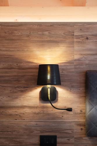 a lamp sitting on the floor in a room at La Dila Dolomiti Mountain Lodge in Andalo