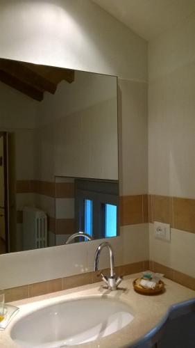 a bathroom with a sink and a large mirror at Villa Cantoni in Gropello Cairoli