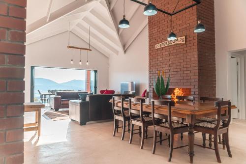 a dining room with a brick wall and a table and chairs at Wolfkop Nature Reserve in Citrusdal
