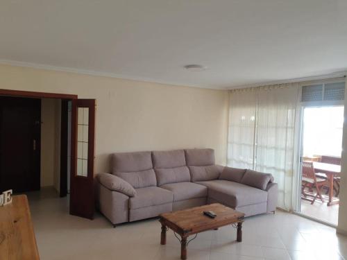 a living room with a couch and a coffee table at Piso para vacaciones en Alicante in Alicante