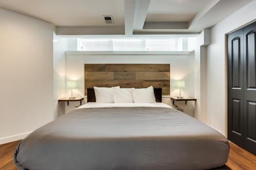 a bedroom with a large bed with two night stands at Converted Store Front Home Lets You Live Like a Local in the Heart of it All! condo in Chicago