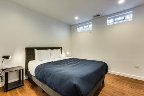 a bedroom with a large bed and two windows at Converted Store Front Home Lets You Live Like a Local in the Heart of it All! condo in Chicago