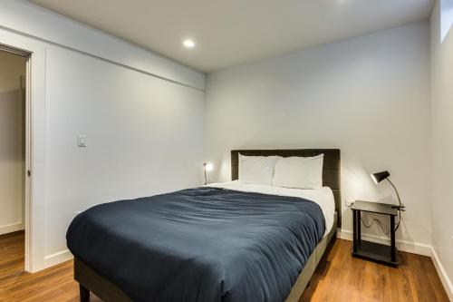 a bedroom with a large bed in a white room at Converted Store Front Home Lets You Live Like a Local in the Heart of it All! condo in Chicago
