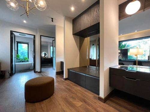 a large living room with a brown ottoman and a room at S.House168 in Chiang Mai