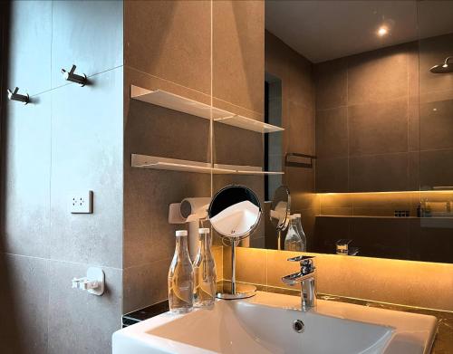 a bathroom with a sink and a mirror at S.House168 in Chiang Mai