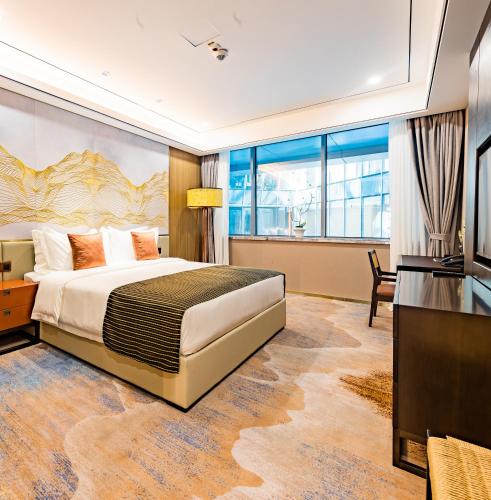a hotel room with a large bed and a television at LDS Hotel Belgrade in Belgrade
