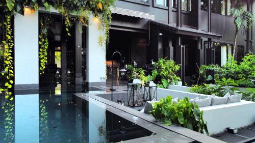 a building with a courtyard with plants on it at S.House168 in Chiang Mai
