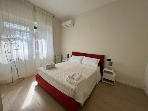 a bedroom with a bed with two towels on it at Ma Petite Maison in Naples