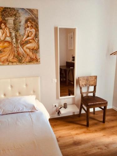 a bedroom with a bed and a chair and a mirror at Dolce Nera B&B in Narni Scalo