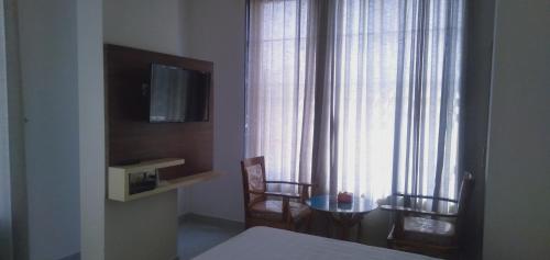 Hotel Success Residencyにあるテレビまたはエンターテインメントセンター