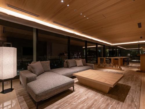 a living room with a couch and a coffee table at THE BLOSSOM KUMAMOTO in Kumamoto