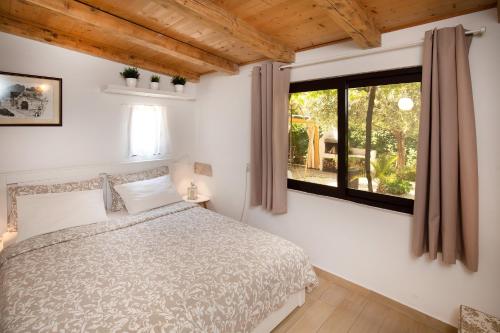 a bedroom with a bed and a window at Apartments Mario 2 in Pula