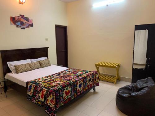 a bedroom with a bed and a chair at Krimson Bricks Homestay in Varanasi