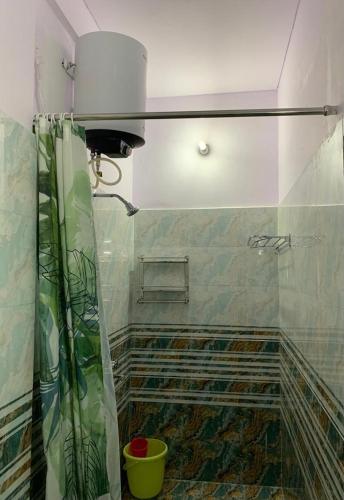 a bathroom with a shower and a shower curtain at Krimson Bricks Homestay in Varanasi