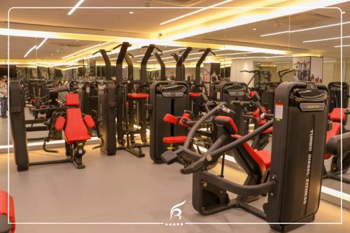 a gym with lots of cardio equipment in a building at Best Inn Erbil - Shorash in Erbil