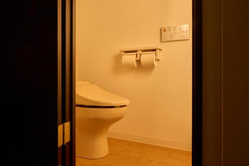 a bathroom with a toilet and two rolls of toilet paper at WPÜ HOTEL HAKONE in Hakone