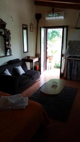 a living room with a couch and a table at CASETTA RAFFO in Castellabate