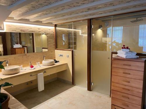 a bathroom with two sinks and a large mirror at Hotel Finca Ca N'ai - Adults Only in Sóller
