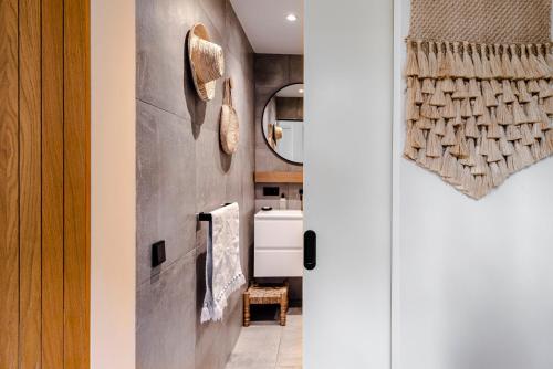 a kitchen with a wall mounted towel rack next to a door at Suite-Suite luxury private guesthouse in Zandvoort