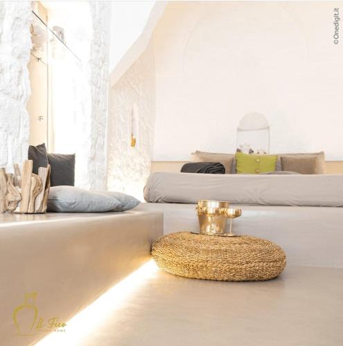 a room with two beds and a bowl on the floor at Il Fico Deluxe in Ostuni