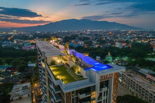 a building with a view of a city at night at Astra Sky River Condo in Chiang Mai