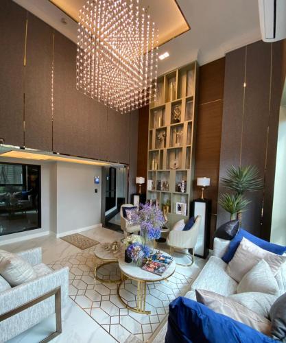 a living room with a couch and a table at Astra Sky River Condo in Chiang Mai