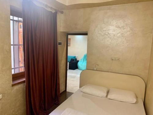 a bedroom with a bed with two pillows on it at Luxury Apartment with jacuzzi on Republic Square in Yerevan