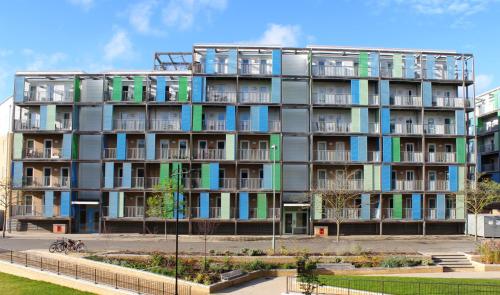 an apartment building with colorful windows and a park at Citystay Living- Warren Close in Cambridge