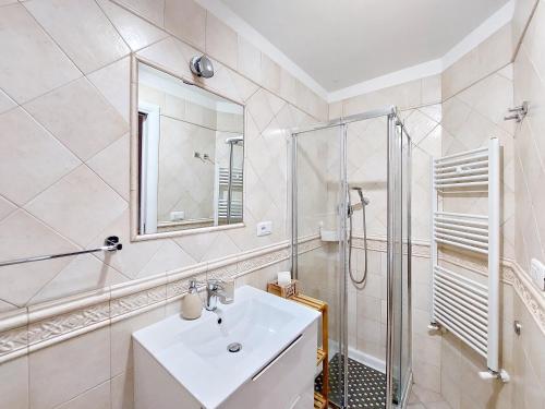 a white bathroom with a sink and a shower at Casa vacanze LaCorte ByFrancy in Bari