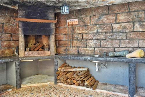 a room with a brick wall with a fireplace at Vista Mar, a Home in Madeira in Ponta do Sol