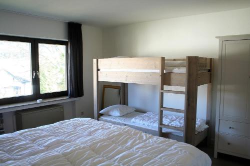 a bedroom with a bunk bed next to a window at Auf der Platte 2 in Winterberg
