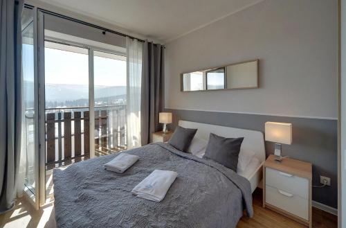 Posteľ alebo postele v izbe v ubytovaní Apart Invest Perła B6