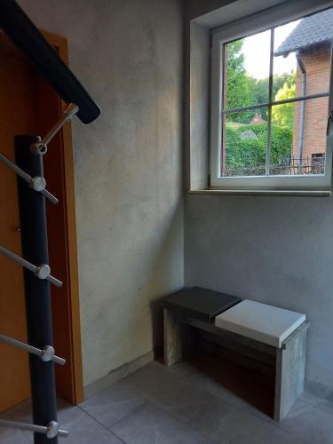 a bench sitting in a room with a window at Appartement Spatzennest in Mossautal
