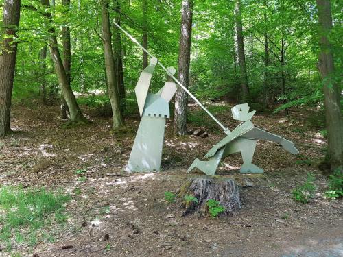 two sculptures of dogs in the woods at Appartement Spatzennest in Mossautal