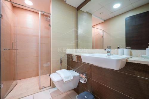 a bathroom with a sink and a toilet and a shower at KeyHost - Spacious Studio at Sparkle Tower Dubai Marina - K1280 in Dubai