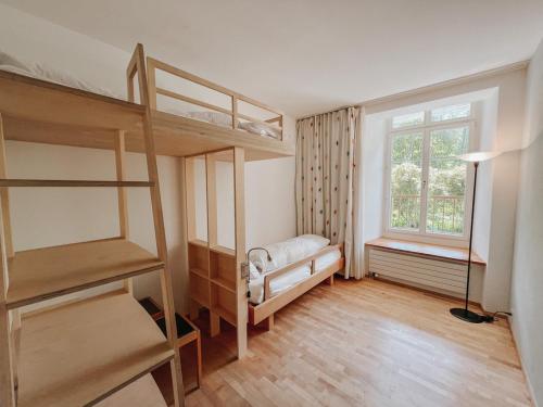 a bedroom with two bunk beds and a window at Schloss Wartegg in Rorschacherberg