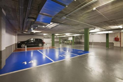 a parking garage with a blue basketball court in it at Sensation Sagrada Familia in Barcelona