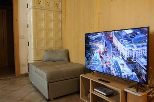 a living room with a flat screen tv and a couch at Tabia studio - Colle Santa Lucia in Villagrande