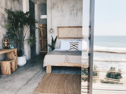 a bedroom with a bed with a view of the ocean at Morena Boutique Hotel Weligama in Midigama