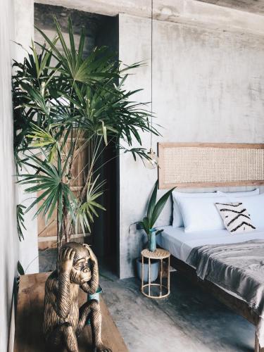 a stuffed monkey sitting on a table in a bedroom at Morena Boutique Hotel Weligama in Midigama