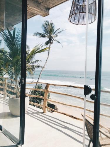 a room with a view of the beach at Morena Boutique Hotel Weligama in Midigama