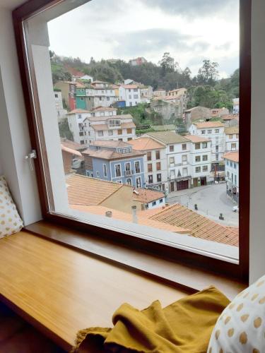 a window with a view of a city at Apartamentos la Garita - Casa Miro y Marianita - Cudillero in Cudillero