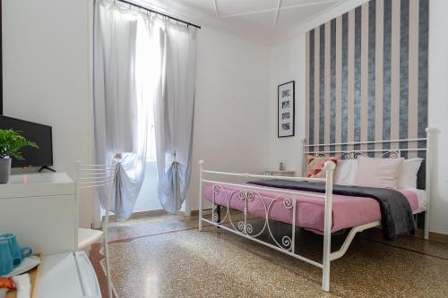 a bedroom with a pink bed and a window at Zaira b&b in Rome