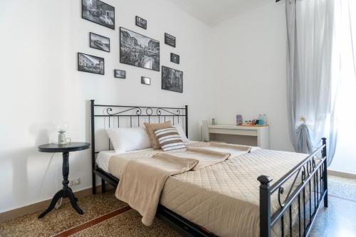 a bedroom with a bed and a wall with pictures at Zaira b&b in Rome