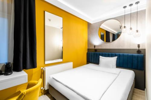 Postel nebo postele na pokoji v ubytování Alta Moda Fashion Hotel