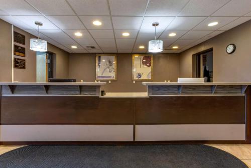 a waiting room with a reception counter and a clock at Howard Johnson by Wyndham Billings in Billings