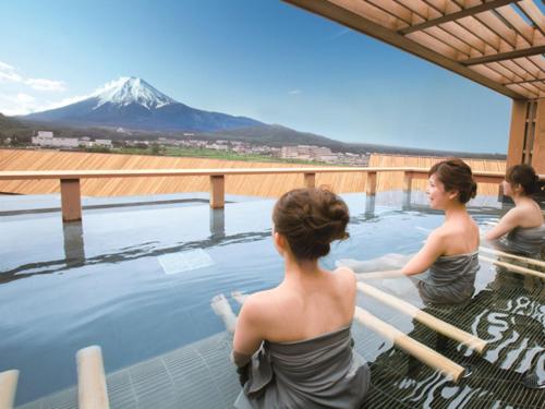 a group of women standing in a pool with a mountain in the background at Bessho Sasa in Fujiyoshida