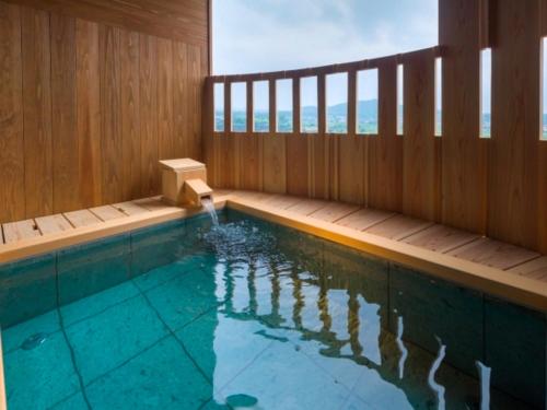 a swimming pool with a wooden deck and a swimming pool at Bessho Sasa in Fujiyoshida